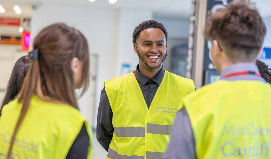 A group of three people standing together in an airport terminal.