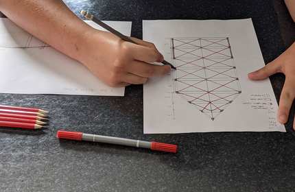 Close-up of an architectural plan being sketched by hand.