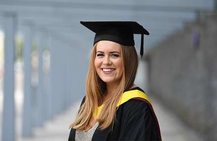 Headshot of Eleri Davies in their graduation cap and gown