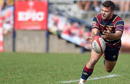 A rugby player passing a rugby ball.