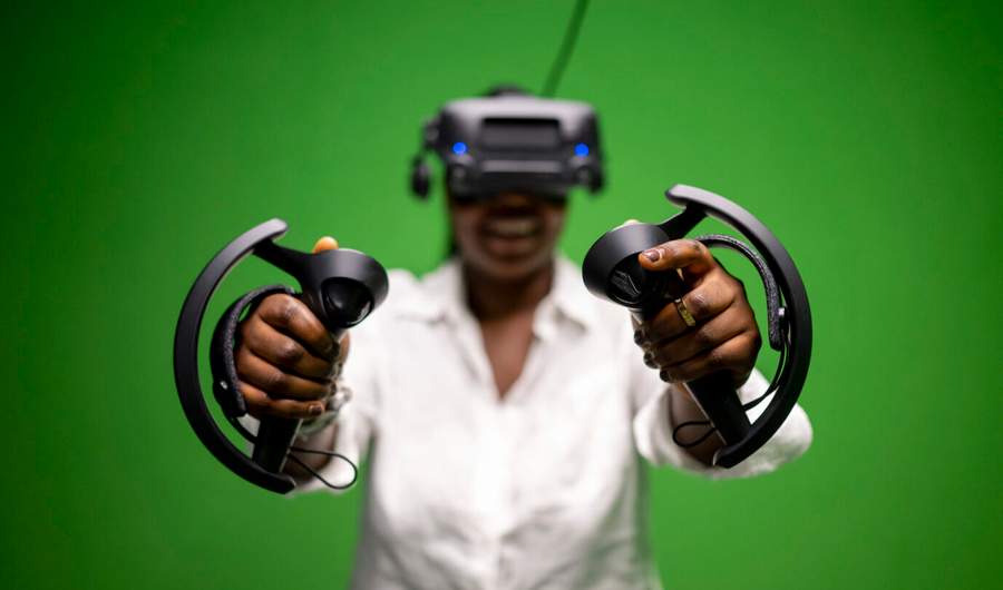 Student wearing virtual headset and holding controllers