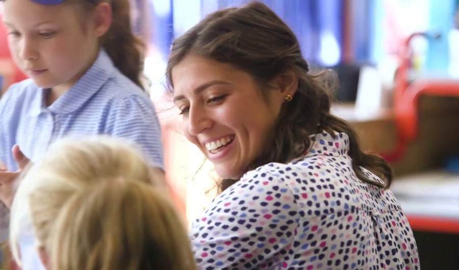 Teacher smiles at pupil
