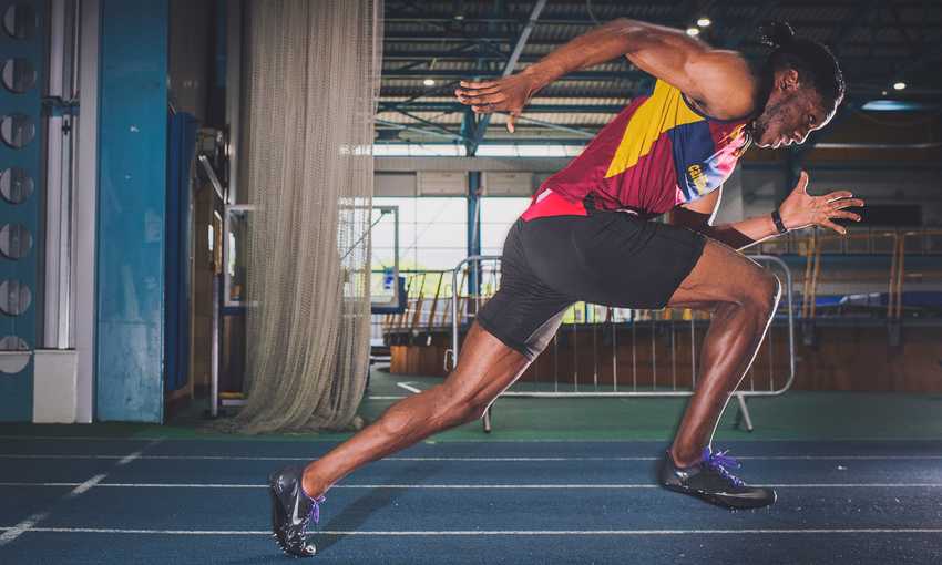 Side view of sprinter running on a track