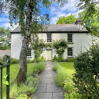 The exterior view of the building housing the holiday home, showcasing its architecture and surrounding landscape.