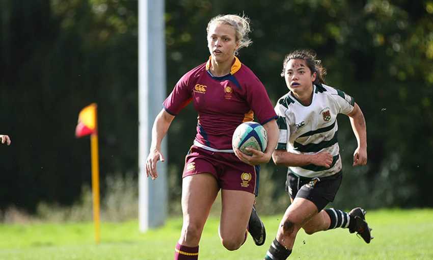 A Cardiff Metropolitan University rugby player runs with the ball during a game