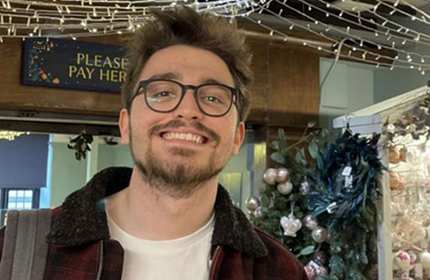 A person tilting their head up and smiling for the camera