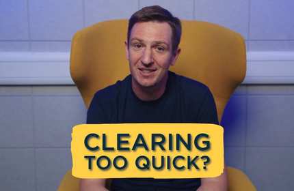 A man sits on a yellow chair with the text 'Clearing too quick?' in front of them