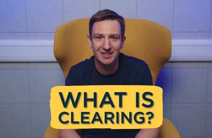 A man sits on a yellow chair with the text 'What is Clearing?' in front of them