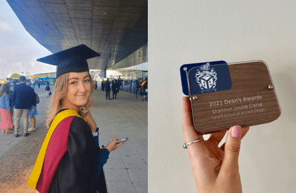 A graduate in cap and gown smiles while holding a diploma outdoors. Beside her, a hand displays a plaque reading 2021 Deans Awards Shannon Louise Clarke Cardiff School of Art and Design.